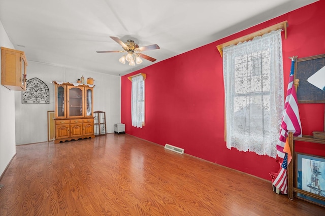 unfurnished living room with hardwood / wood-style floors and ceiling fan