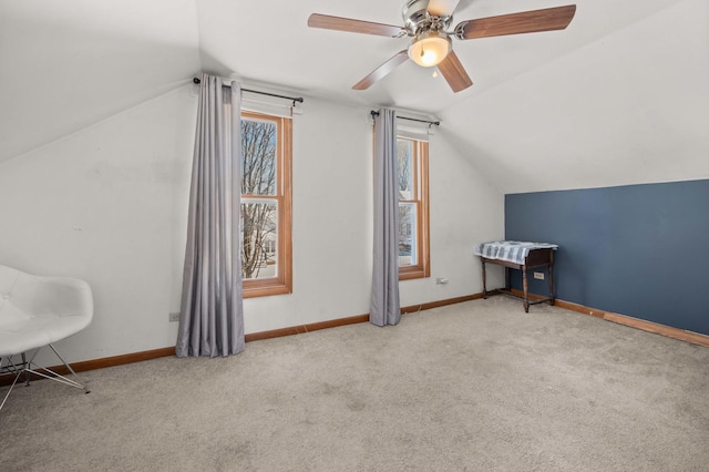 additional living space with lofted ceiling, light colored carpet, and ceiling fan