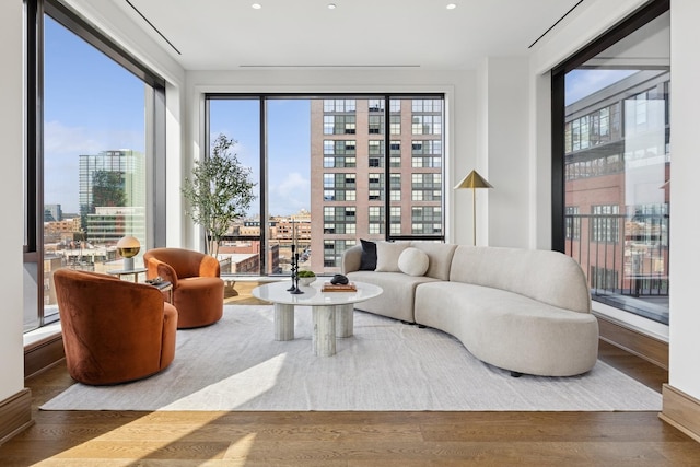 interior space featuring recessed lighting, plenty of natural light, a city view, and wood finished floors