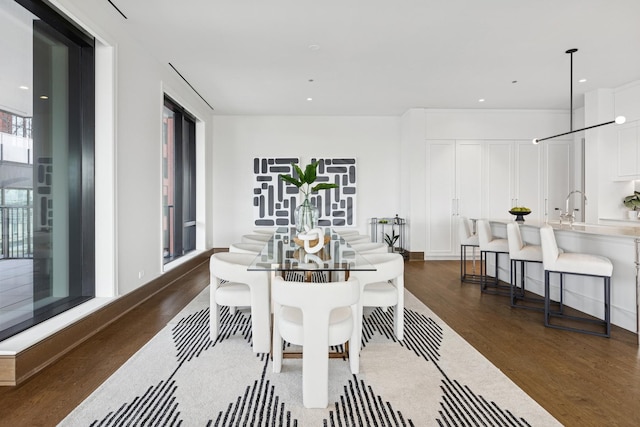 dining room with dark wood-style flooring and recessed lighting