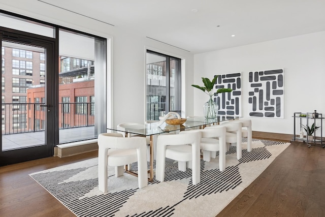 dining space with plenty of natural light and wood finished floors