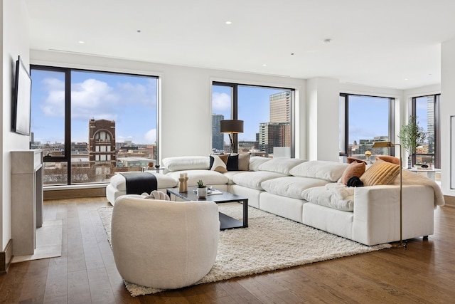 living room featuring a view of city, hardwood / wood-style floors, and recessed lighting