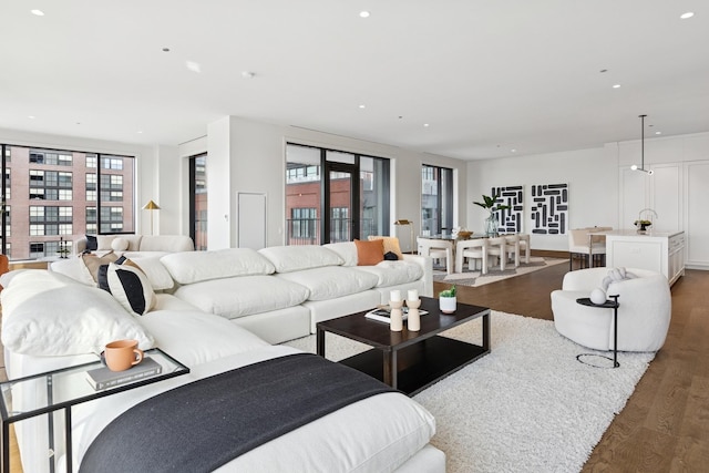 living room with recessed lighting and wood finished floors