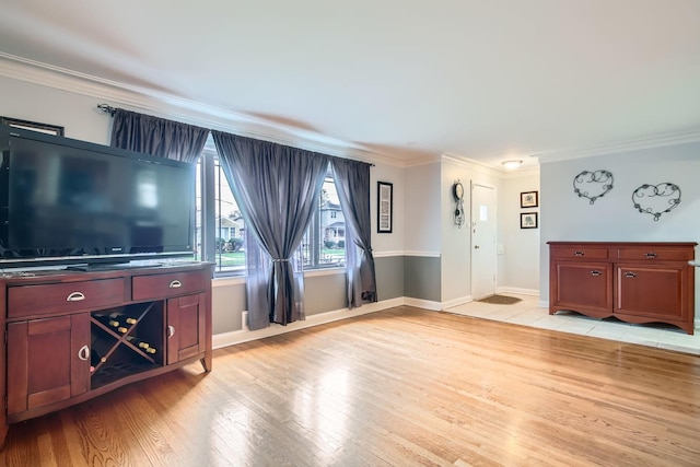 unfurnished living room with crown molding and light hardwood / wood-style floors