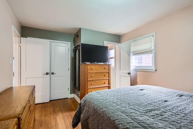 bedroom featuring a closet and light wood-type flooring