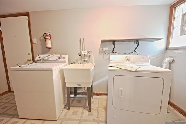 washroom with washing machine and clothes dryer