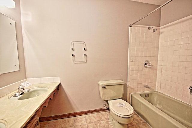 full bathroom with tiled shower / bath, vanity, and toilet