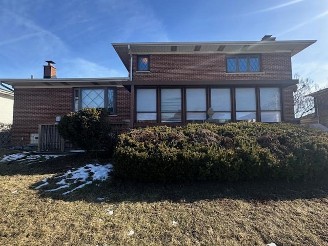 rear view of house with a lawn