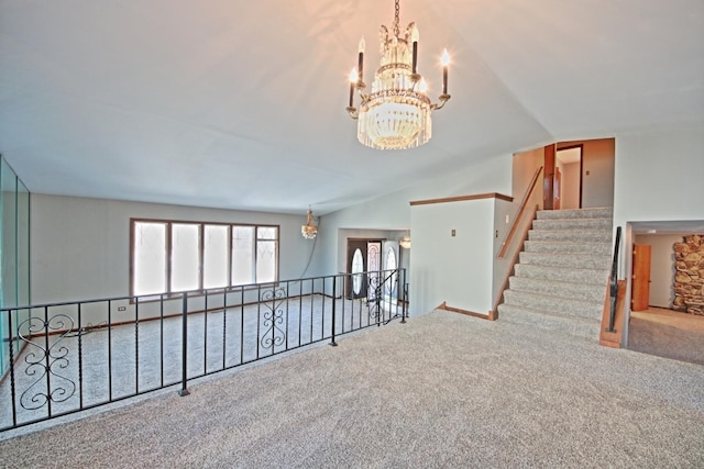 empty room featuring vaulted ceiling, carpet, and a chandelier