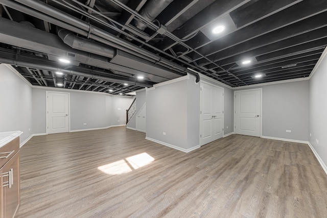 basement with light hardwood / wood-style floors