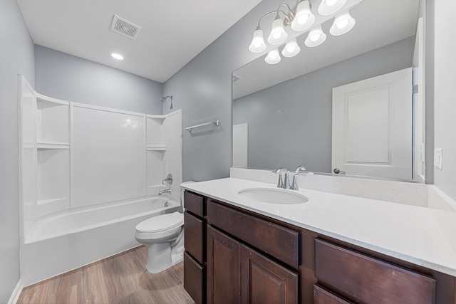 full bathroom featuring vanity, bathtub / shower combination, hardwood / wood-style floors, and toilet