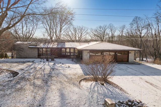 view of front of home with an attached garage and stone siding