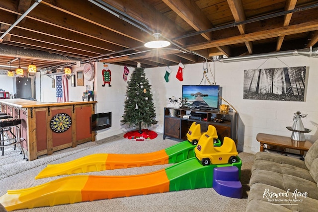 basement with indoor bar and carpet