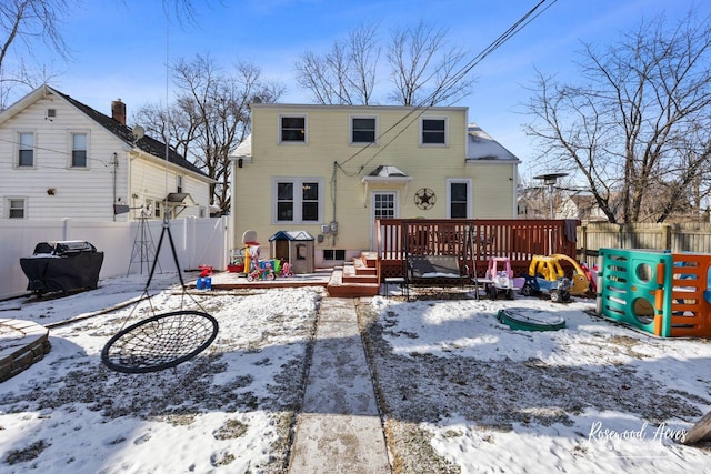 view of snow covered rear of property