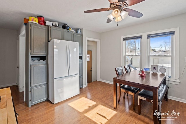 kitchen with ceiling fan, light hardwood / wood-style flooring, and white fridge