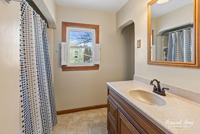 bathroom with vanity, curtained shower, and tile patterned floors