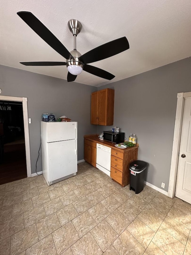 kitchen featuring white appliances and ceiling fan