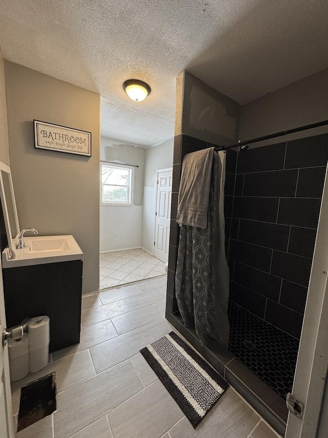 bathroom featuring vanity, a textured ceiling, and a shower with shower curtain