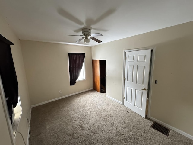 unfurnished room with ceiling fan and carpet floors