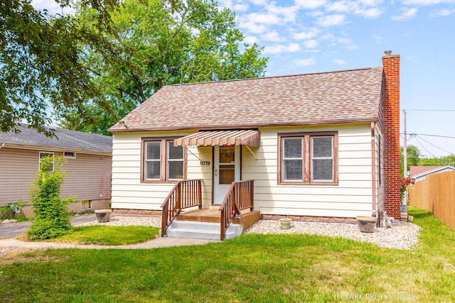 bungalow-style house with a front yard