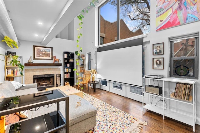 living room with a high ceiling and hardwood / wood-style floors