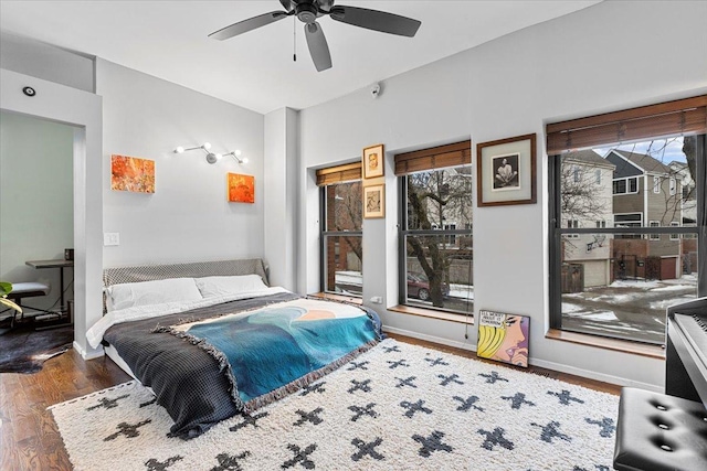 bedroom featuring dark wood-type flooring and ceiling fan