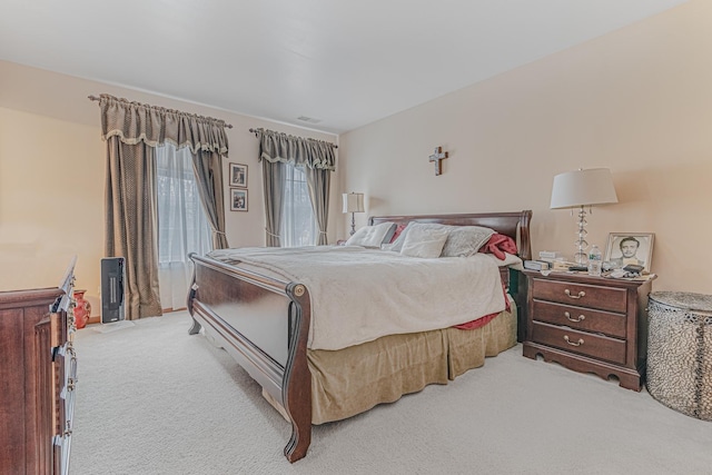 bedroom featuring light carpet