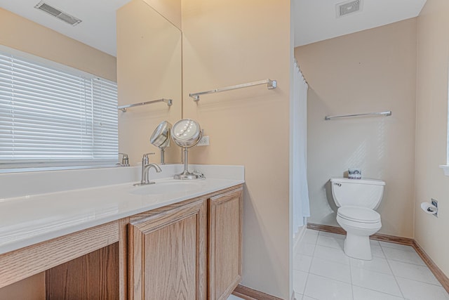 bathroom with toilet, tile patterned floors, and vanity