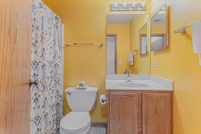 bathroom featuring vanity and toilet