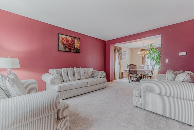 living room with a notable chandelier and carpet flooring