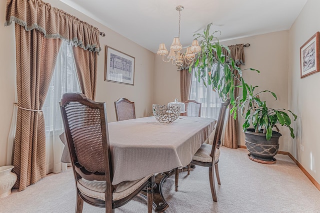 carpeted dining room featuring a notable chandelier