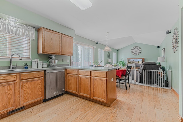 kitchen featuring light hardwood / wood-style floors, dishwasher, sink, kitchen peninsula, and pendant lighting