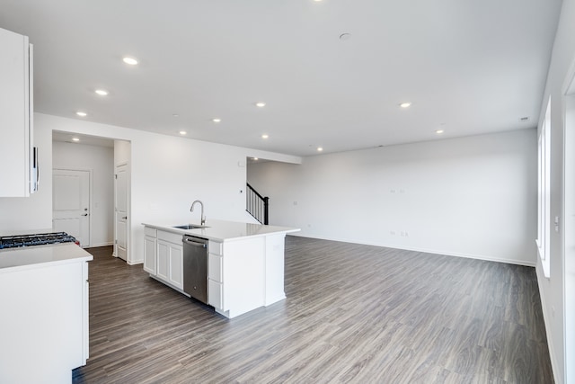 kitchen with a kitchen island with sink, wood finished floors, a sink, white cabinets, and stainless steel dishwasher