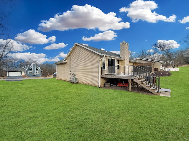 rear view of house with a wooden deck, a yard, and central air condition unit