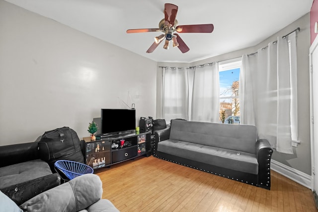 living room featuring ceiling fan and hardwood / wood-style flooring