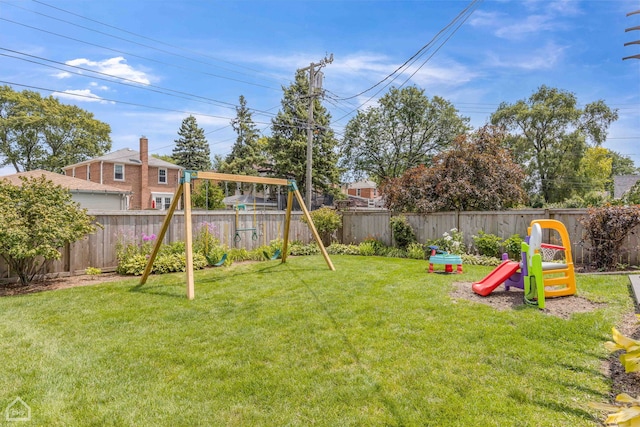 view of yard featuring a fenced backyard and a playground