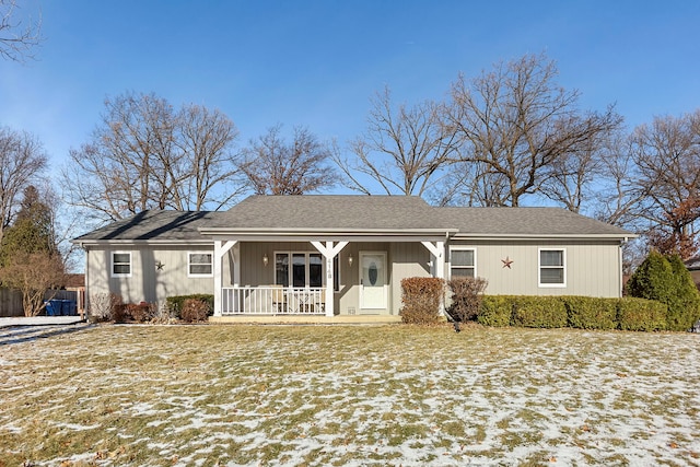 ranch-style home with a porch and a lawn