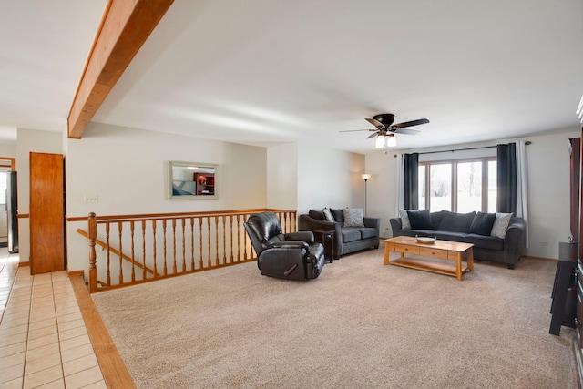 tiled living room with beam ceiling and ceiling fan