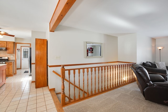 hallway featuring beam ceiling and light tile patterned floors