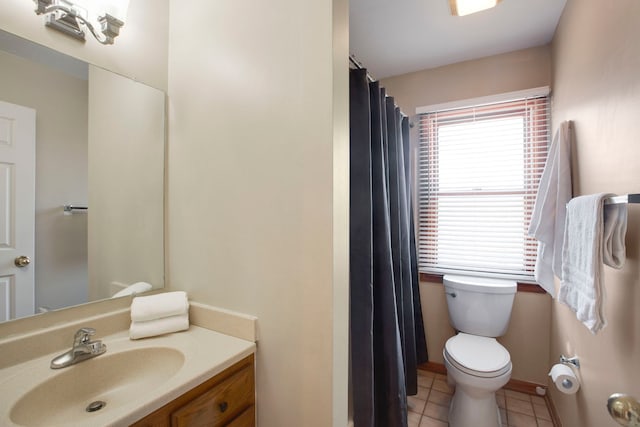 bathroom featuring tile patterned flooring, vanity, plenty of natural light, and toilet