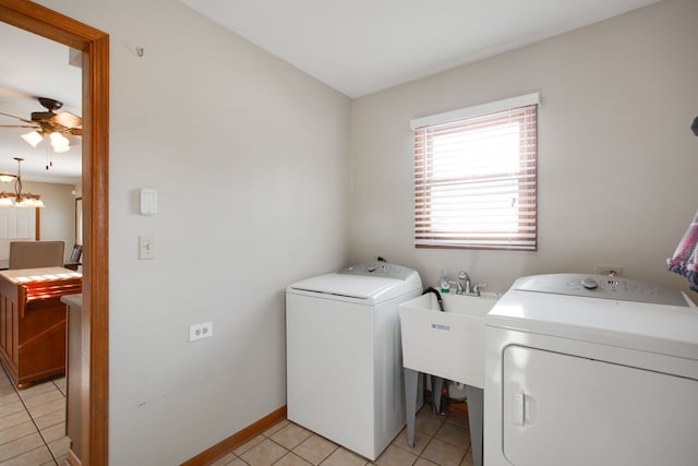 washroom featuring light tile patterned flooring, washing machine and clothes dryer, sink, and ceiling fan with notable chandelier