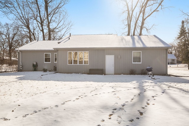 view of snow covered rear of property