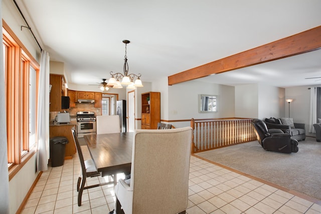 dining space featuring ceiling fan with notable chandelier and light carpet