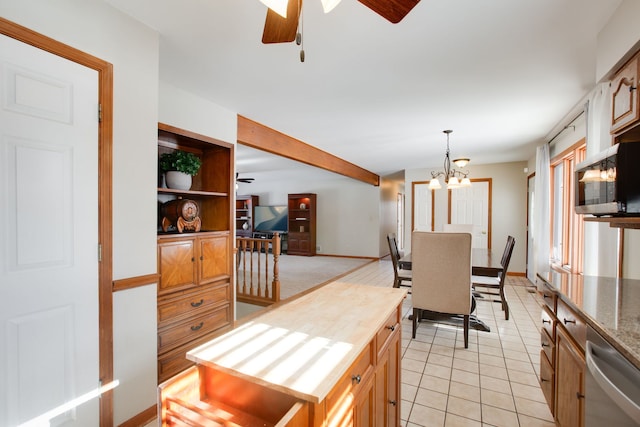 kitchen with pendant lighting, light tile patterned floors, ceiling fan with notable chandelier, and appliances with stainless steel finishes