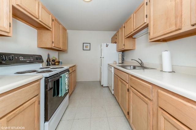 kitchen with light brown cabinetry, sink, and white appliances