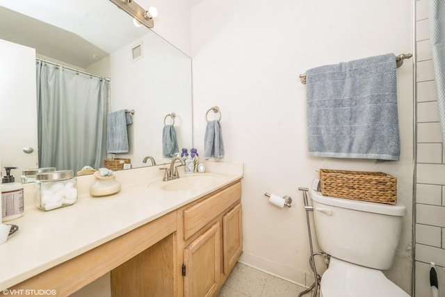 bathroom with toilet and vanity