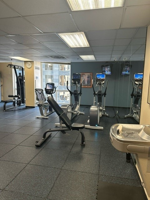 exercise room with a paneled ceiling