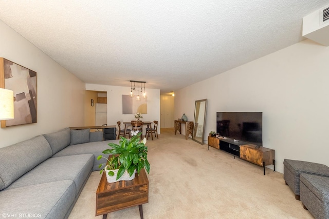 living room featuring carpet floors and a textured ceiling