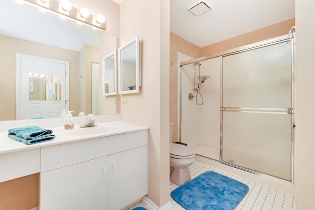 bathroom featuring tile patterned floors, an enclosed shower, and vanity