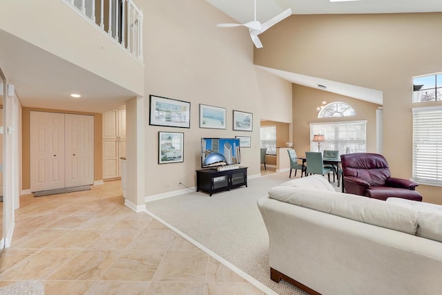 living room with ceiling fan, light colored carpet, and high vaulted ceiling